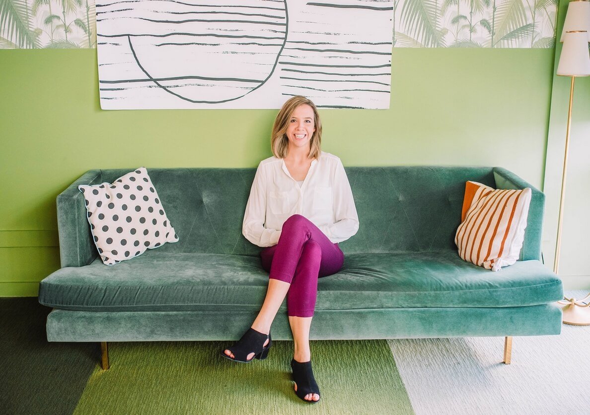 Julia McCoy on a sofa